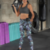Woman lifting weights in gym wearing NCharnt high-waist leggings with blue and purple butterfly Woman lifting weights in gym wearing NCharnt high-waist printed leggings with blue and purple butterfly
