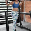 Woman lifting weights in gym wearing NCharnt Blue and Purple Butterfly Gym Leggings