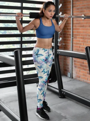 Woman lifting weights in gym wearing NCharnt Blue and Purple Butterfly Gym Leggings