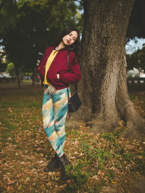 Woman wearing Ncharnt Ankle-length Teal and Yellow Leggings standing in forest Woman wearing Ncharnt Ankle-length Teal and Yellow Leggings standing in forest