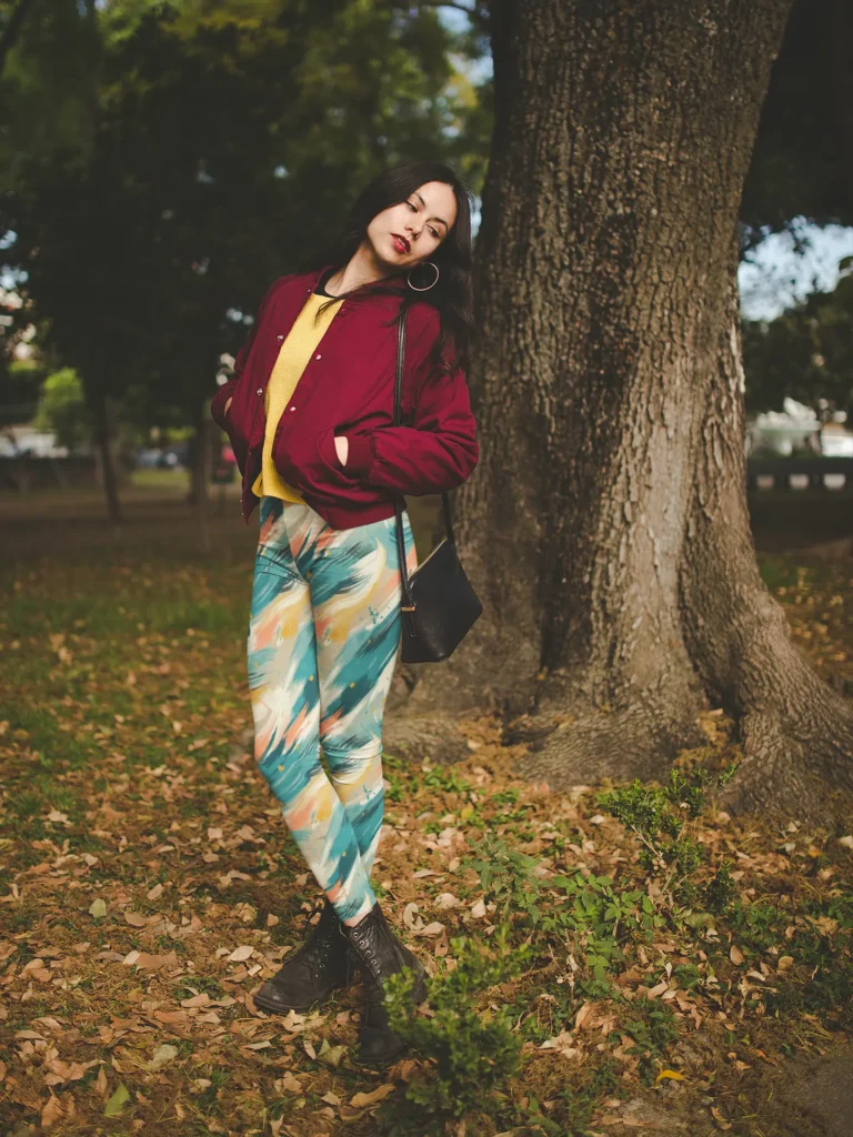 Woman wearing Ncharnt Ankle-length Teal and Yellow Leggings standing in forest