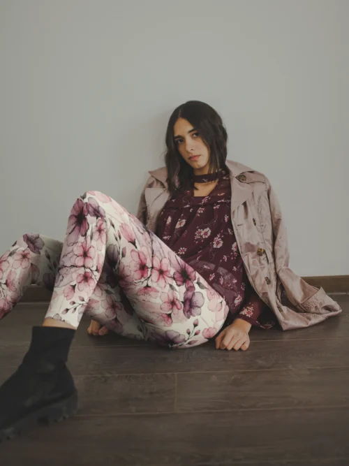 Girl wearing NCharnt Pastel Pink and Purple floral leggings sitting on floor Girl wearing NCharnt Pastel Pink and Purple floral leggings sitting on floor