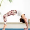 Woman wearing NCharnt Pastel Pink and Purple floral leggings doing yoga