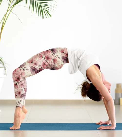 Woman wearing NCharnt Pastel Pink and Purple floral leggings doing yoga Woman wearing NCharnt Pastel Pink and Purple floral leggings doing yoga