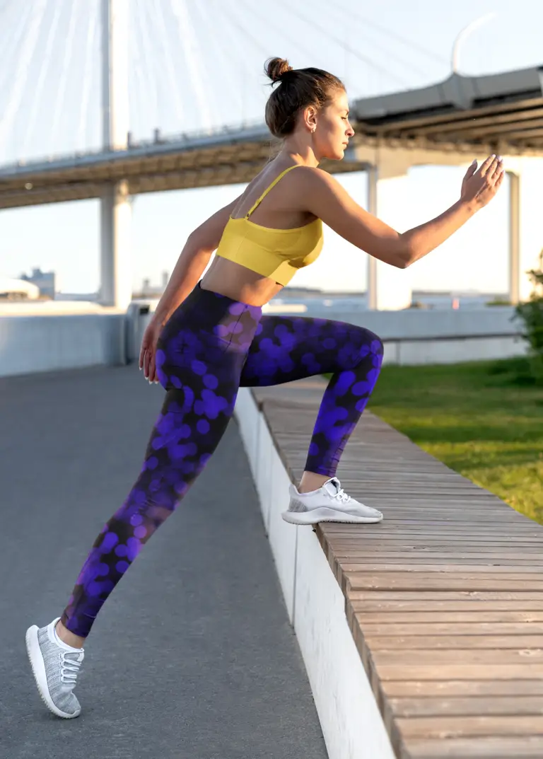 Woman doing workout wearing NCharnt Black leggings with electric blue pattern