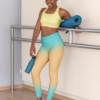 Girl with yoga mat wearing NCharnt trendy sports leggings in blue and orange ombre