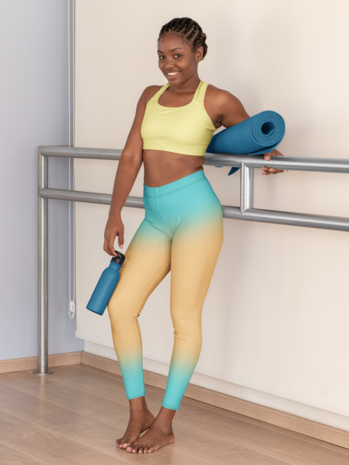 Girl with yoga mat wearing NCharnt trendy sports leggings in blue and orange ombre Girl with yoga mat wearing NCharnt trendy sports leggings in blue and orange ombre