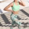 Woman posing on stairs wearing NCharnt peach and green ankle length women's workout leggings