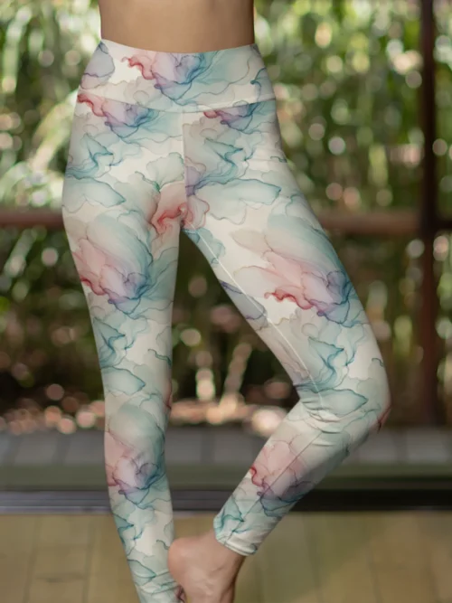 Woman wearing NCharnt high-waist gym leggings in multicolor fluid pattern Woman wearing NCharnt high-waist gym leggings in multicolor fluid pattern