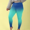 Woman wearing NCharnt printed gym tights in light and dark blue Ombre