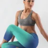 Woman wearing Ncharnt printed gym tights light and dark blue ombre doing yoga pose