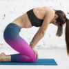 girl wearing NCharnt fashionable gym leggings in blue and purple doing yoga
