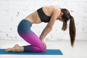 girl wearing NCharnt fashionable gym leggings in blue and purple doing yoga