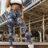 Woman wearing NCharnt printed leggings, high-waisted, with Blue and purple butterfly print, standing Woman wearing NCharnt printed leggings, high-waisted, with Blue and purple butterfly print, standing