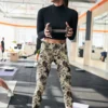 Woman lifting weights wearing NCharnt Beige and black tie dye print classy yoga leggings Woman lifting weights wearing NCharnt Beige and black tie dye print classy yoga leggings