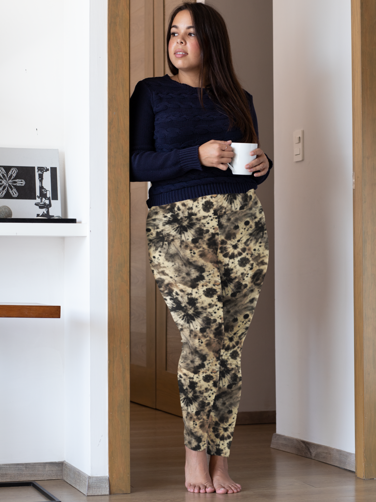 Woman standing against door wearing beige and black tie dye classy yoga leggings