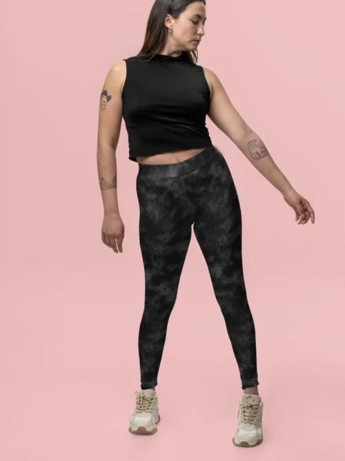 Woman standing and pointing in NCharnt Grey and Black Texture print leggings Woman standing and pointing in NCharnt Grey and Black Texture print leggings