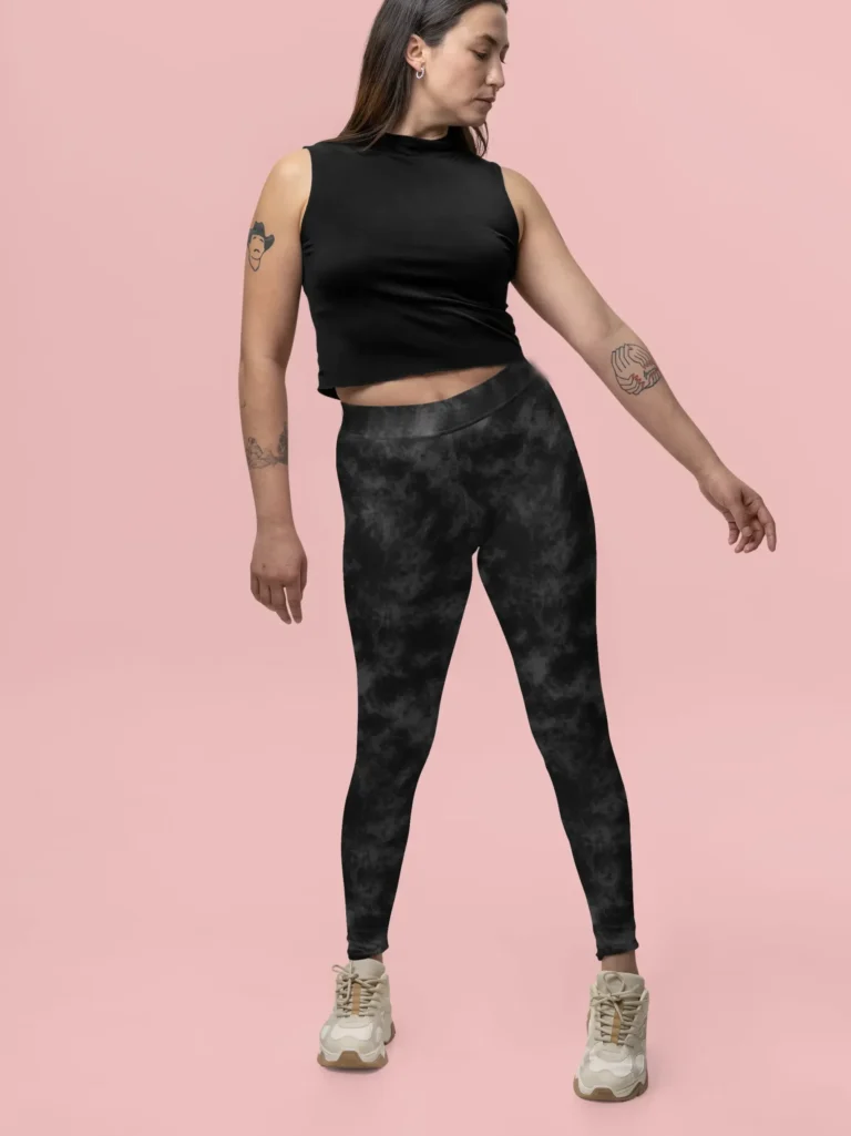 Woman standing and pointing in NCharnt Grey and Black Texture print leggings